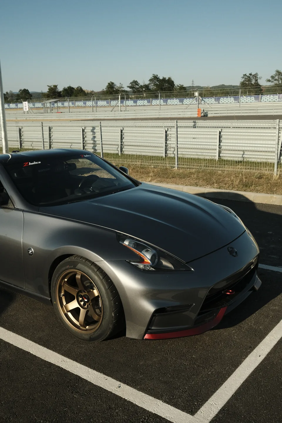 Zholics 370Z Stillen in silver with bronze wheels, front three-quarter view